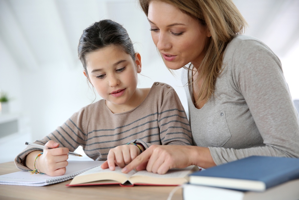 Mom helping kid with homework