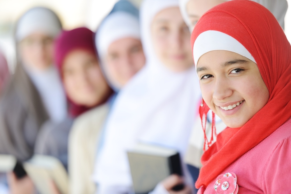 Muslim and Arabic girls standing together in line row.jpeg