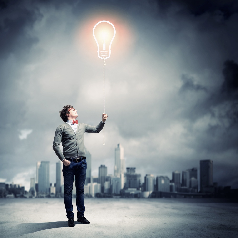 Young man holding a light at his hands against polluted and ruined landscape.jpeg