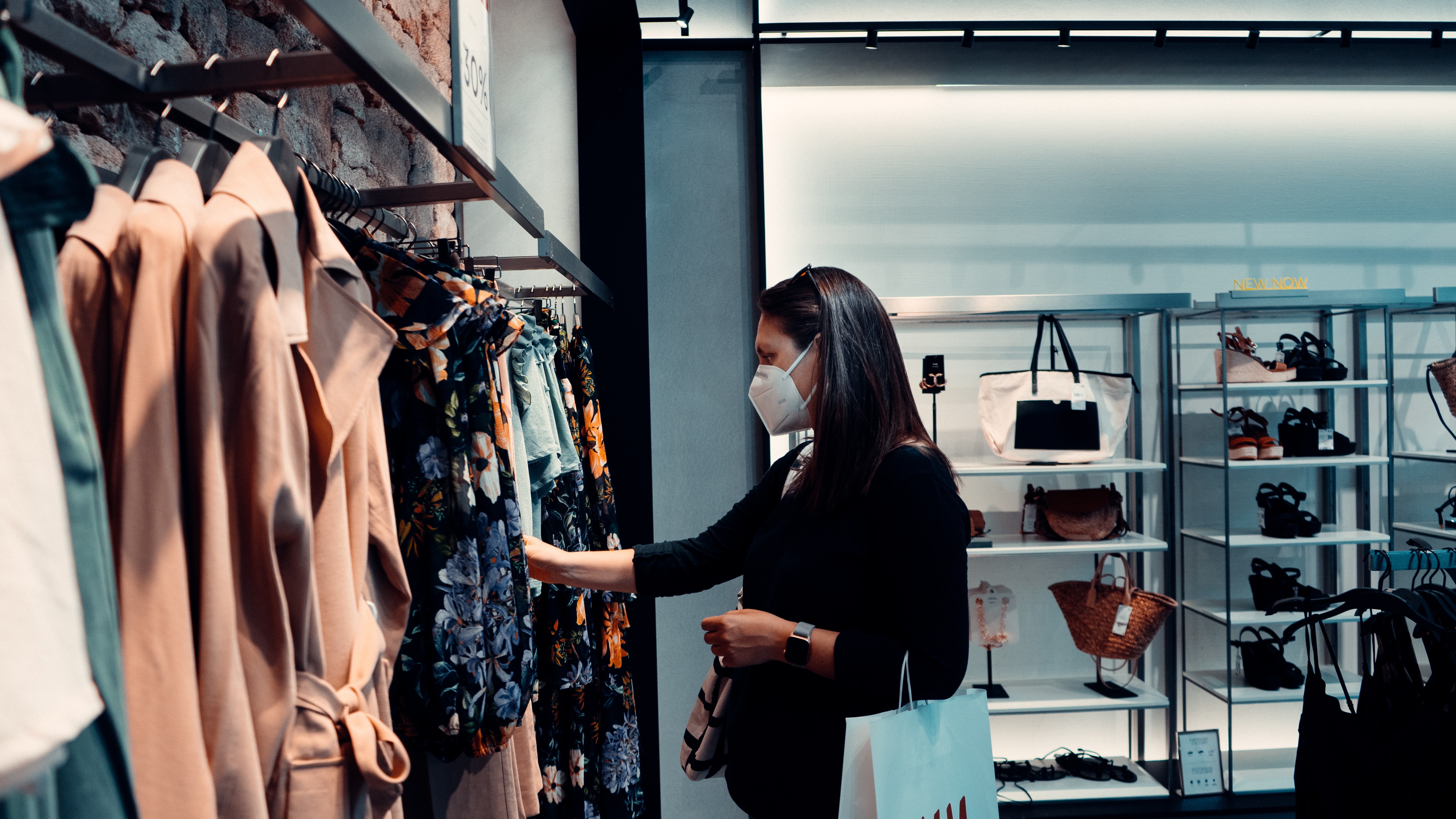 Hispanic Female shopping for clothes in KN95 Mask