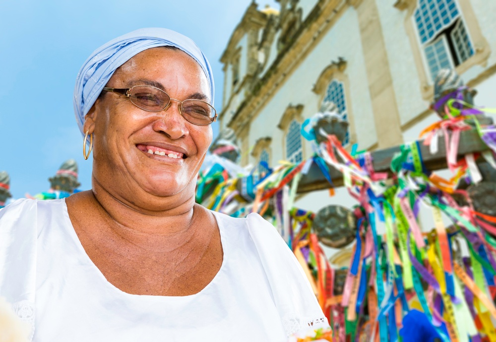 A Brazilian woman of African descent, smiling, wearing traditional clothes in Salvador, Bahia.jpeg